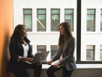 Two women sitting by a window