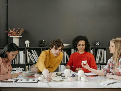 A team of employees collaboratively solving problems with imagination and insight, representing the rising value of human soft skills in the workplace