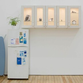 Yoni Zonszein, Paper Stones from The Metropolitan Museum of Art, from the Great Temple of the Aten at Amarna and Related Fragments Dynasty 18, reign of Akhenaten, ca1353 - 1336 B.C. / 2012-2015 A.D. Indurated Limestone, Diorite, Red Quartzite, Kitchen Cabinet, TungstenLamp, Black Toned Xerox Prints, White Bond Paper, regrigerator, notes,fern and ironing board97 x 96 x 27 inches