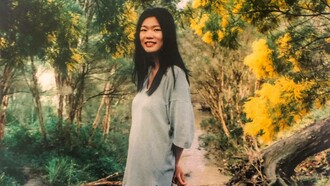 A young Kim Chi Pho in a garden in the middle of autumn