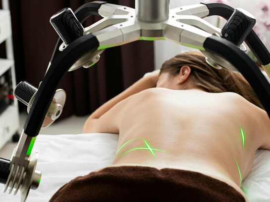 A patient receiving a non-invasive laser-assisted procedure, reflecting the growing preference for treatments with minimal downtime