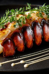 Lobster tail prepared as a premium culinary experience, symbolising the social prestige attached to certain foods