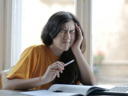 A young woman suffering from headaches