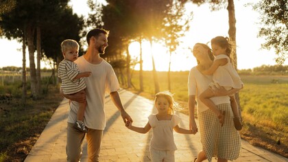 Bathed in the warm glow of sunset, a family enjoys a leisurely walk together, celebrating connection and togetherness