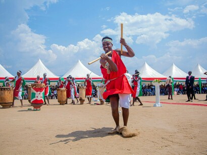 A performer dancing energetically in ceremonial attire, illustrating how tradition shapes community values