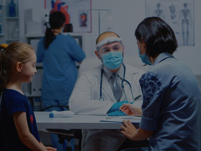 Ensuring safety during the COVID-19 pandemic, a pediatrician specialist in medicine, equipped with a mask, delivers essential healthcare services, consultations, and treatments to children in a hospital environment