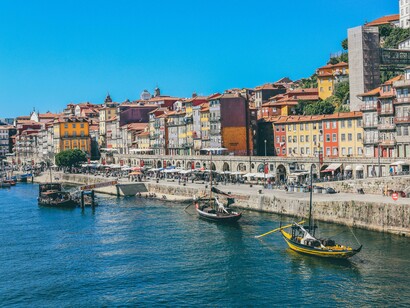 Boats drifting along the Douro River in Porto, Portugal, symbolising the city’s true connection to tradition and trade