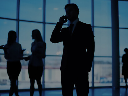 Silhouettes of professionals engage in discussions, illustrating diplomatic negotiations and fostering international cooperation