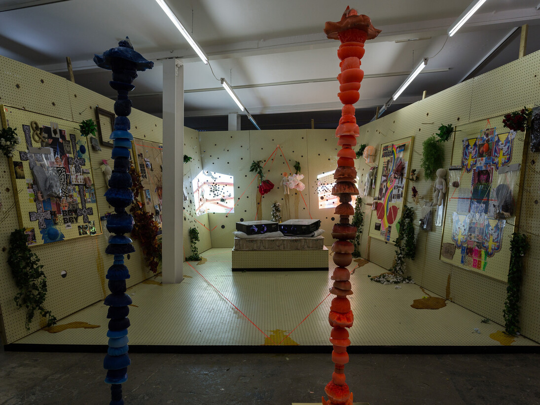 Stephen G. Rhodes, Altar of the Eleventh Hobby to the Portal of the Incubus Lobby: Pride and Lust, 2014
2 channel video, sound channel, pegboard altar, vibrating mattress, various hobby lobby merchandise, dimensions variable, courtesy Vilma Gold, London
