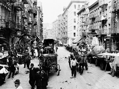 Crowded street market in New York City's Little Italy, where Italian immigrant families and local vendors brought Mulberry Street to life