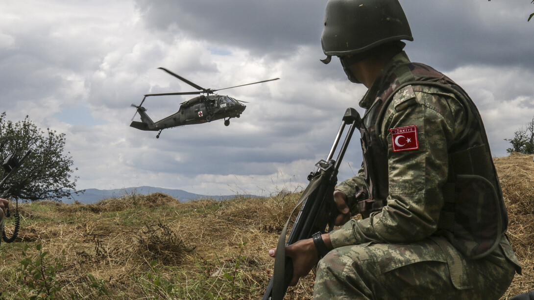 A Turkish soldier, with Multinational Battle Group-East, watches as a UH-60 Black Hawk gets ready to land after receiving a 9-line call for a simulated casualty. U.S. and NATO forces have contributed to the United Nations-mandated peacekeeping mission in Kosovo since June 1999