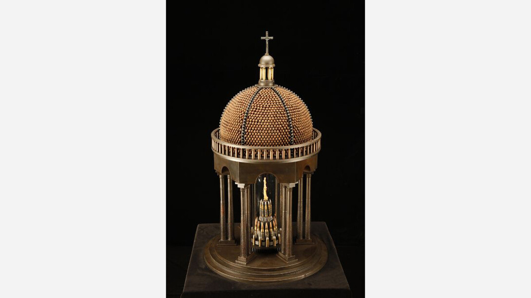 Al Farrow, The Middle Finger of Santo Guerro, 2021-2022. Gun parts, bullets, cartridge shells, gears, steel, glass, bone, and crucifix. Courtesy of the artist and Catharine Clarke Gallery