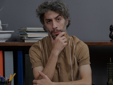 A disillusioned artist wrestling with writer’s block at a table, immersed in existential reflection on the literary world