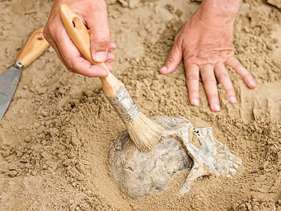 An archaeologist diligently conducting excavations at the site