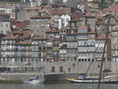 Ribeira, located in Porto, Portugal, is an atmospheric and vibrant riverfront medieval district that boasts World Heritage status, exuding a captivating blend of colors and history along its picturesque streets