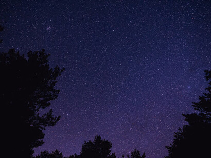 The night sky, filled with twinkling stars, mirrors the dreams and aspirations of those who seek escape from the isolation of their realities