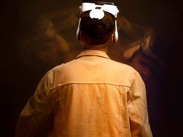 A man wearing VR glasses, immersed in a virtual experience