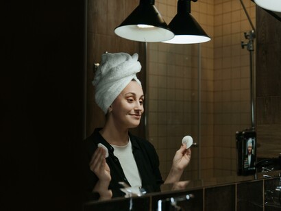 Woman using cotton pads in a bathroom