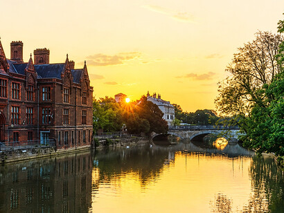 Sunrise over the River Great Ouse in Bedford, United Kingdom, casting warm reflections across the calm waters and historic riverside scener