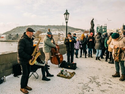 A saxophonist and double-bass player entertaining visitors on Charles Bridge, reflecting Prague’s love for music in public spaces