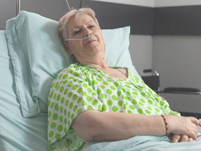 A sick woman lying in a hospital bed