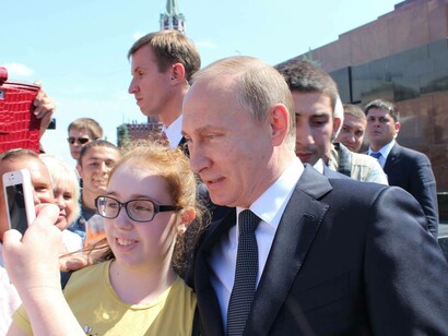 Russian President Vladimir Putin took the time from his war with Ukraine to pose for a selfie with a female fan