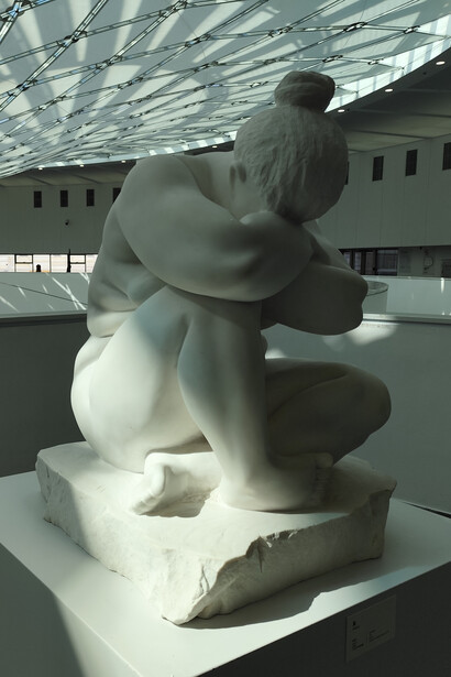 Rather than stylized or humorous, the figure is raw, realistic, and weighty