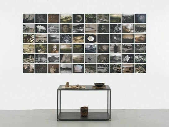 Michelle Stuart (American, born 1931), Ring of Fire, 2008-09/2010, Wall piece: inkjet-printed analog photographs, archival paper, 58 x 119 inches, Metal table: stones, wood container, seeds, Tonga tapa cloth, cotton cloth, basket, 28 ½ x 40 x 18 inches, 2013 © Michelle Stuart, Courtesy Leslie Tonkonow Artworks + Projects, New York
