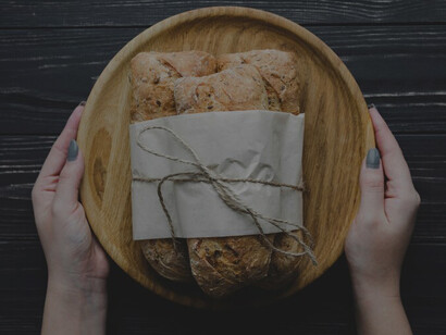 Hands carefully tying a bunch of freshly baked buns, a labor of love for a delicious homemade snack