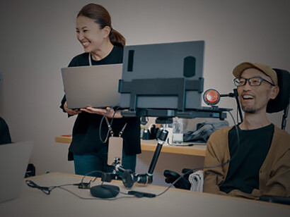 People with varying abilities working together in a small office environment