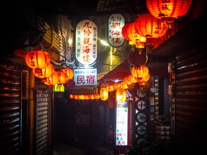 Warm orange pendant lamps illuminated at night, showcasing Taiwan's cultural charm