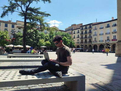 An expat man working on his laptop—balancing professional life while living overseas