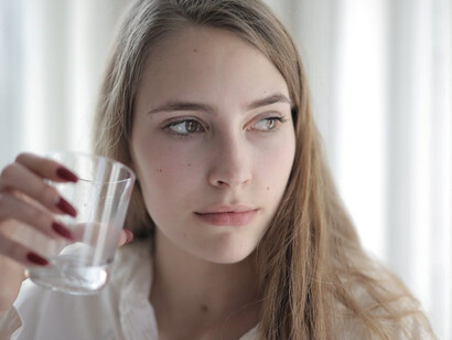 A woman is taking a sip of water