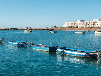 Traditional fishing boats resting on the calm waters of the Bouregreg River, representing the connection between Morocco’s maritime heritage and Rabat’s cultural transformation