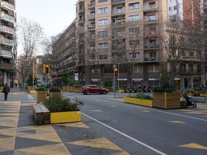 A city street in Barcelona, Spain, featuring a bike lane and smart traffic management, exemplifying a smart city