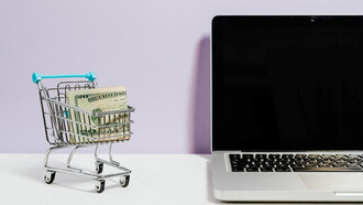 Next to a notebook, there is a miniature trolley