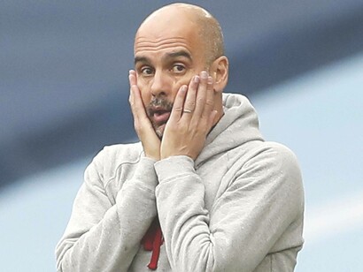 Manchester City manager Pep Guardiola with hands on his cheeks to indicate worry