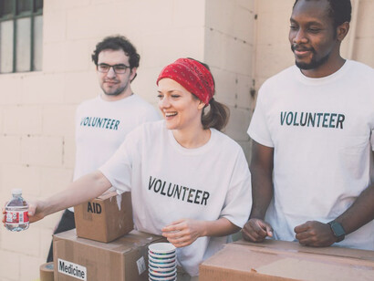 Young volunteers extending a helping hand by distributing food to those in need