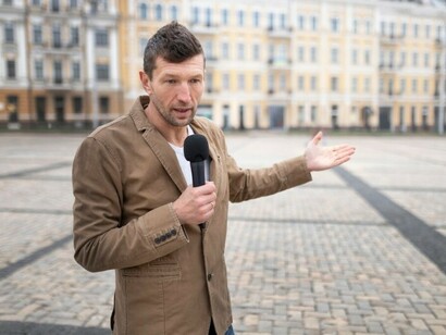 A reporter prepares for a news interview on the street