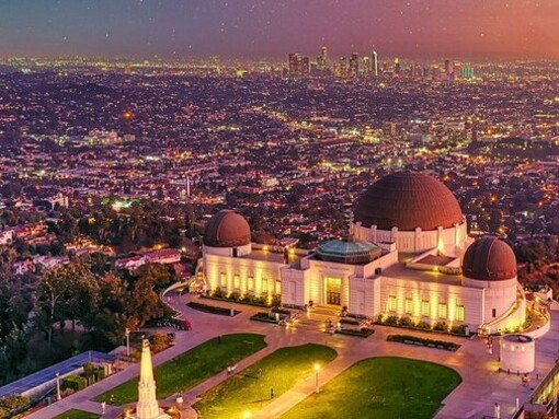 Griffith Observatory overlooking the glowing Los Angeles skyline, reflecting the city's spirit of exploration and imagination