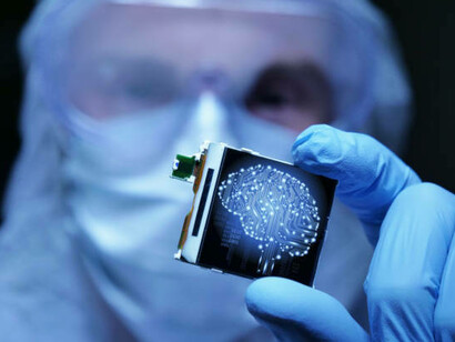 A design engineer in a sterile coverall stands inside an ultra-modern electronics factory, holding a microchip with futuristic holographic visuals symbolizing organ-on-chip technology