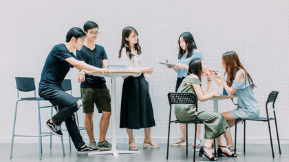 Two men and four women meeting in office