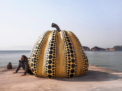 Naoshima Island, Japan: A polka dot Yayoi Kusama pumpkin greets us on a pier