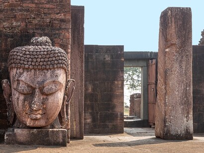 Buddha and ruins at Ratnagiri archaeological site, Odisha, India