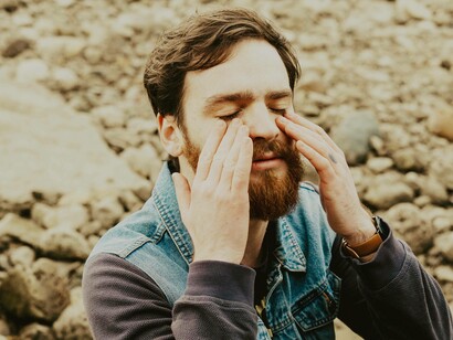 A man massaging his cheekbones after he has been told that he has ADHD