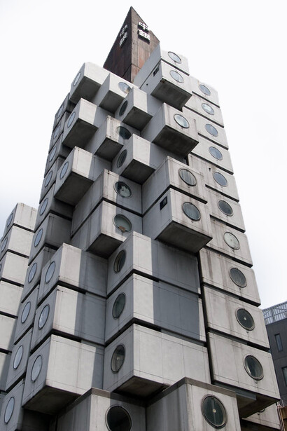Exterior view of the Nakagin Capsule Tower in Tokyo, Japan, featuring its modular capsule apartments