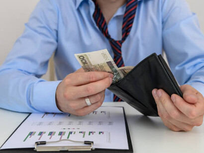 With an empty wallet in hand, a man reflects the harsh realities of poverty and the pressing need for a living wage