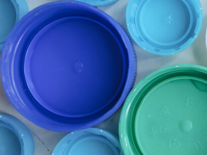 Blue and green plastic bottle caps ready for recycling