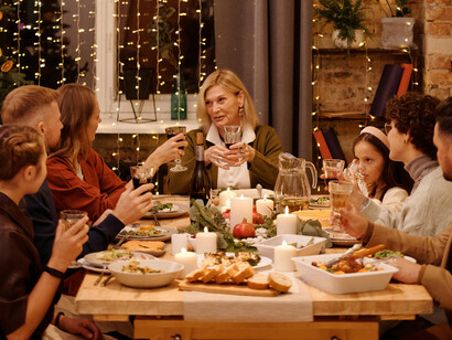 A middle aged woman proposing a toast with her family