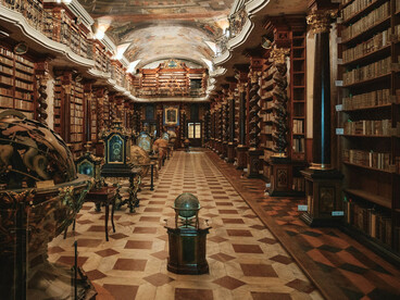The richly decorated interior of the Klementinum’s historic library in Prague,  symbolizing the connection between books, art, and the pursuit of knowledge